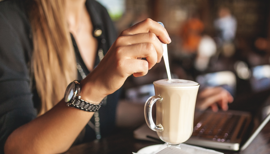 Woman with coffee at work by snowball creations linkedin ads agency linkedin advertising digital marketing services