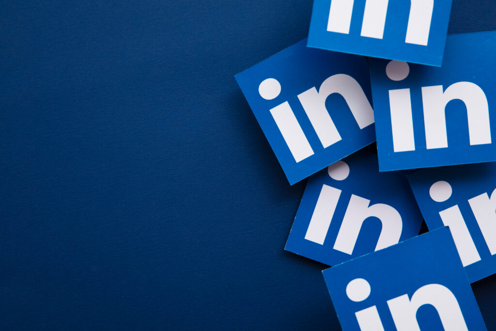 A bunch of LinkedIn logos on a blue background.