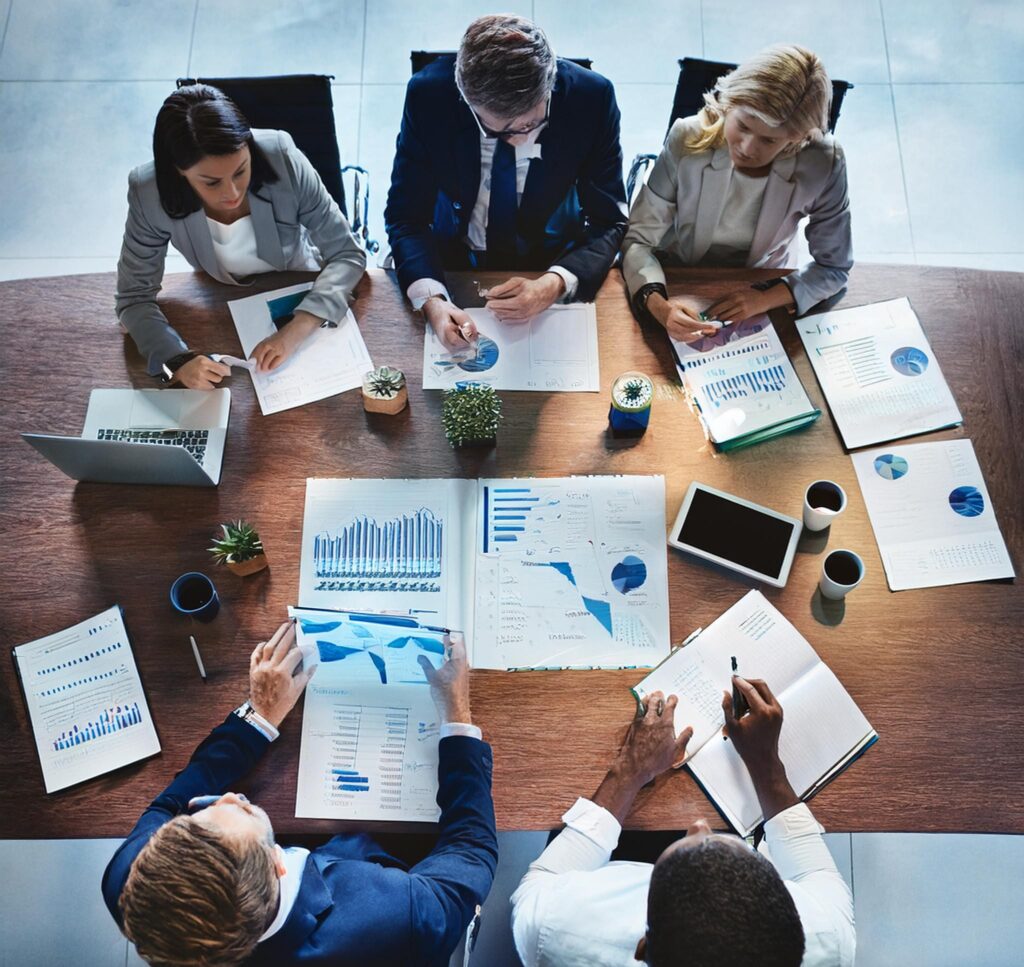 People sitting around a table working on marketing reports